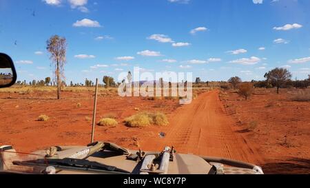 Driving down a desert track to a secluded campsite near Uluru, Northern Territory, Australia Stock Photo