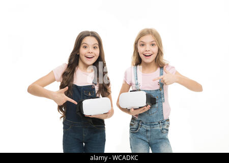 Cyber gaming. Virtual reality is exciting. Girls little kids wear vr glasses white background. Virtual education concept. Modern life. Interaction in virtual space. Augmented reality technology. Stock Photo