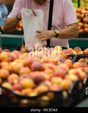 Biodegradable plastic food bags in the fruits and vegetables aisle in a big hypermarket in Romania Stock Photo