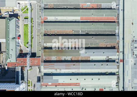 roof of large warehouse at city industrial area, aerial top view Stock Photo