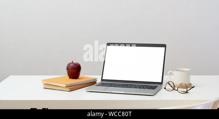 Minimal workplace concept : open blank screen laptop with office supplies and decorations Stock Photo