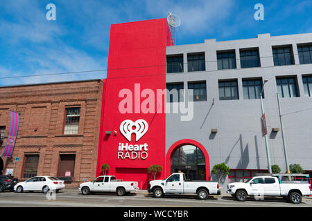 iHeart Radio sign and logo on company office facade. iHeartRadio is a free broadcast and internet radio platform owned by iHeartMedia - San Francisco, Stock Photo