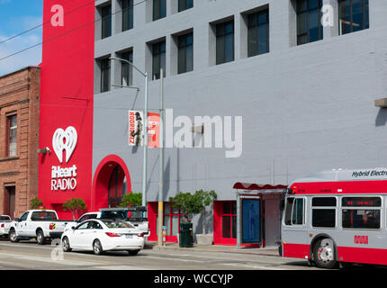 iHeart Radio sign and logo on company office facade. iHeartRadio is a free broadcast and internet radio platform owned by iHeartMedia - San Francisco, Stock Photo