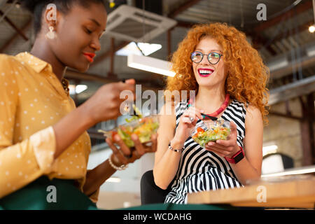 Good-looking office workers eating lunch together in the office Stock Photo
