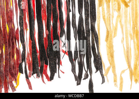 Various types of fresh homemade pasta. Raw pasta drying process. Isolated on white background. Stock Photo