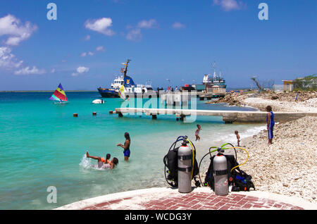 Diving cylinders at the baech, surfer on the sea, Watersport paradise Bonaire, Netherland Antilles Stock Photo