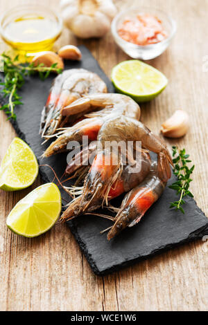 Fresh raw  prawns and spices on  wooden table Stock Photo