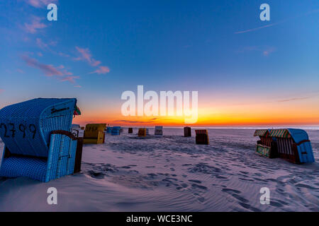 Beach chairs after sunset at the beach on Juist, East Frisian Islands, Germany. Stock Photo