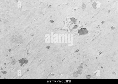 Close-up of a painted, weathered and worn sheet metal plate in black and white. Paint is partly peeled off revealing rusty metal. Abstract background. Stock Photo