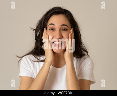 Excited latin teenager girl surprised and shocked feeling amazed by Unbelievable sales, Great news or Success. Woman screaming with overjoy, Euphoric Stock Photo