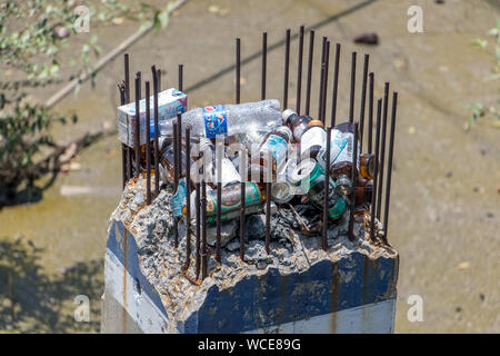 SAMUT PRAKAN, THAILAND, MAY 18 2019, The garbage in the river lying inside to the construction of a concrete pillar on shore. Stock Photo