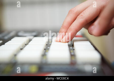 Beat maker producing new track with professional midi controller device in home recording studio.Audio equipment for music production.Disc jockey hand Stock Photo