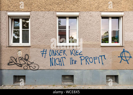 Protest slogan on an old residential building against real-estate investors in Berlin Prenzlauer Berg, Germany.