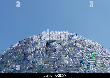 semicircular mountain of plastic waste, plastic bottles with a beautiful blue background Stock Photo