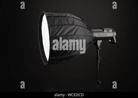 Modern round octobox, on black background. Equipment for photo studios and fashion photography. Photographic lighting. Preparation for studio shooting Stock Photo
