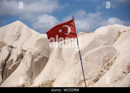 Turkish flag with typical  tuff rock formations of the Cappadocia in background. Göreme National Park, Anatolia Region Turkey Stock Photo
