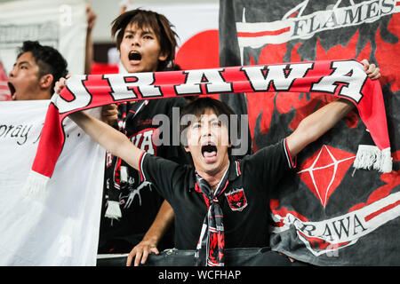 Fans cheer for the Urawa Red Diamonds team at the stand at the Shanghai SIPG F.C. VS Urawa Red Diamonds quarter final match during 2019 Asian Champions League in Shanghai, China, 27 August 2019. Stock Photo