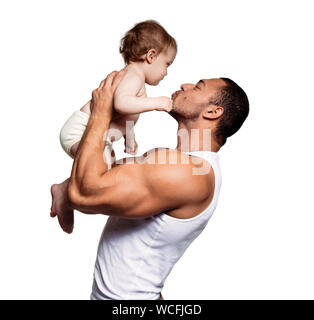 Muscular Father Holding Cute Daughter While Standing Against White Background