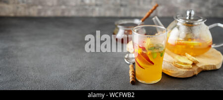 Tea set composition with hot tea on dark grey background Stock Photo