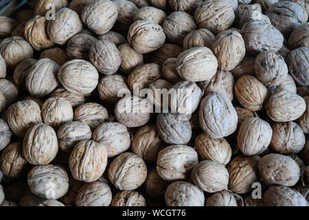 Walnuts with and without shells. Background of fresh walnuts. Stock Photo