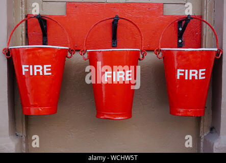 Close-up Of Red Fire Buckets Hanging Outdoors