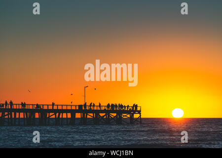 Semaphore Beach  pier with people at sunset, Adelaide, South Australia Stock Photo