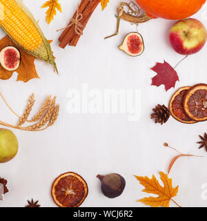 Creative autumn frame with fruits, vegetables, leaves and other symbols and place for text in the center Stock Photo