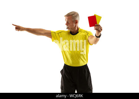 Referee showing a red and yellow cards to a football or soccer player while gaming on white studio background. Concept of sport, rules violation, controversial issues, obstacles overcoming. Stock Photo