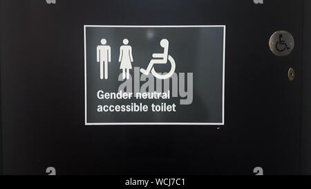 Public convenience sign with male and female symbols and direction