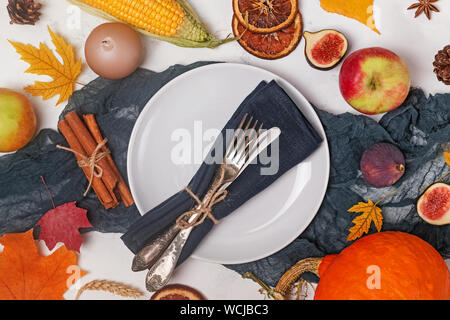 Table decorated with autumn fruits, leaves and spices. Thanksgiving day table setting, top view Stock Photo