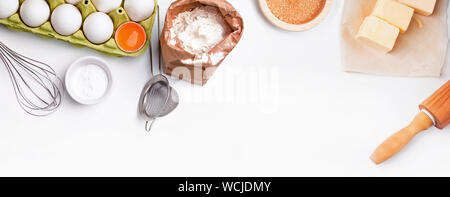 Baking process banner with place for text. Tools and ingredients for baking: flour, eggs, milk and other. Stock Photo