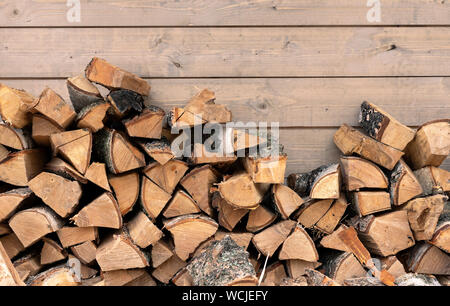 Stacked firewood as background, closeup. Heating house in winter Stock Photo