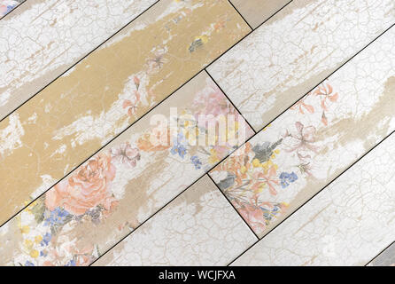 Beige ceramic tiles with floral patterns. Background from beige tiles. Stock Photo