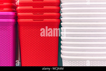 Plastic baskets of different colors on the store counter. Stock Photo