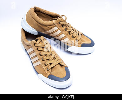 Khaki sports shoes isolated on white background. Casual walking shoes. Stock Photo