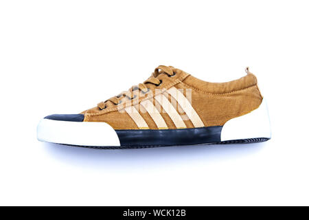 Khaki sports shoes isolated on white background. Casual walking shoes. Stock Photo