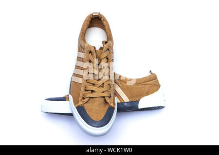 Khaki sports shoes isolated on white background. Casual walking shoes. Stock Photo