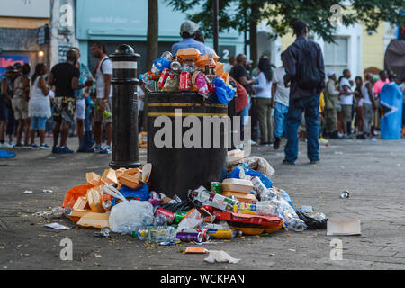 Overflow bin with rubbish after festival. Food package, empty plastic bottles, and another single use plastic elements Stock Photo