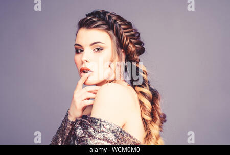 French braid. Professional hair care and creating hairstyle. Braided hairstyle. Beautiful young woman with modern hairstyle. Beauty salon hairdresser art. Girl makeup face braided long hair. Stock Photo