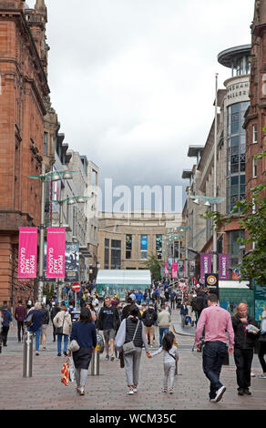 Buchanan Street Glasgow, Scotland, UK. 28th Aug, 2019. Shoppers and visitors wander along in the hazy sunshine through the pedestriansed Buchanan Street in Glasgow city centre. The Donald Dewar statue stands proudly at the top of the street, the inaugural First Minister of Scotland and an advocate of Scottish devolution, one would have to wonder what his thoughts would be regarding today's breaking news that British Prime Minister Boris Johnson has asked the Queen to suspend the UK Parliament from mid-September. Stock Photo