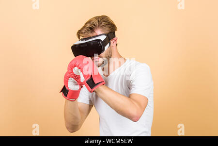 vr boxing. future innovation. man in VR glasses. Futuristic gaming. boxing in virtual reality. Digital sport success. man use new technology. modern gadget. Training boxing game. Dedicated to fitness. Stock Photo