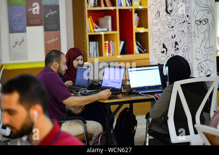 (190828) -- GAZA, Aug. 28, 2019 (Xinhua) -- Palestinian youths work inside Gaza Sky Geeks, one of several local innovation hubs in the Gaza Strip, on Aug. 26, 2019. Hundreds of small business ideas come up in the West Bank and Gaza Strip, but only a small number of them flourishes and continues due to the limitations in the supporting eco-system for the start-ups. TO GO WITH 'Feature: Palestinian start-ups see limited growth' (Str/Xinhua) Stock Photo