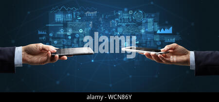 Close up of two hands holding smartphones to sync business data Stock Photo
