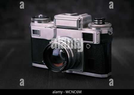 Old vintage film 36mm photo camera, lifestyle memory. Take pictures with a manual lens history. Stock Photo