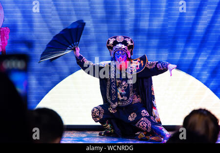 Chengdu, China - July 26, 2019: Face-changing Szechuan Chinese opera theater stunt performance show on stage in Chengdu China Stock Photo