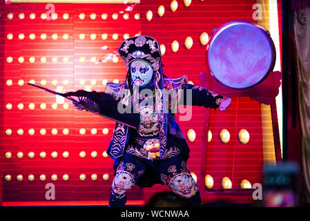 Chengdu, China - July 26, 2019: Face-changing Szechuan Chinese opera theater stunt performance show on stage in Chengdu China Stock Photo