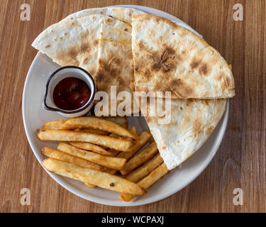 Quesadilla and french fries on plate, shot from above Stock Photo