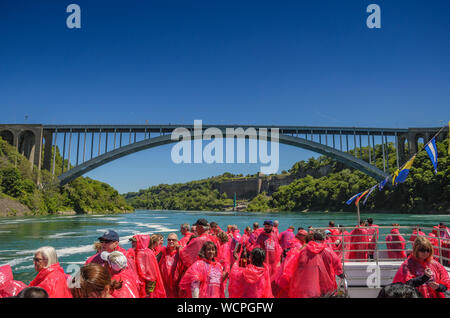 Tourists and visitors experience the natural wonder that is Niagara Falls in a new way, up close and from the water on a cruise ship in Niagara Falls Stock Photo