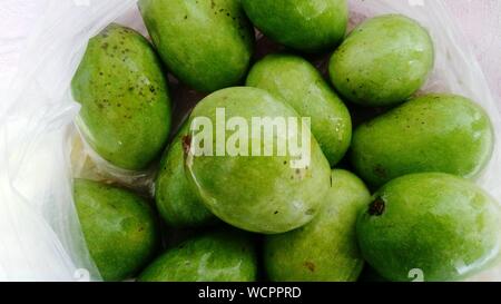 High Angle View Of Raw Mangoes In Plastic