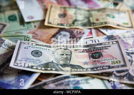 London, UK. 28th Aug, 2019. Pounds notes and US dollars are seen together as the value of the pound falls after the Queen consents to suspension of the UK parliament for five weeks. The Â£ is now worth $1.22. Credit: Steve Taylor/SOPA Images/ZUMA Wire/Alamy Live News Stock Photo